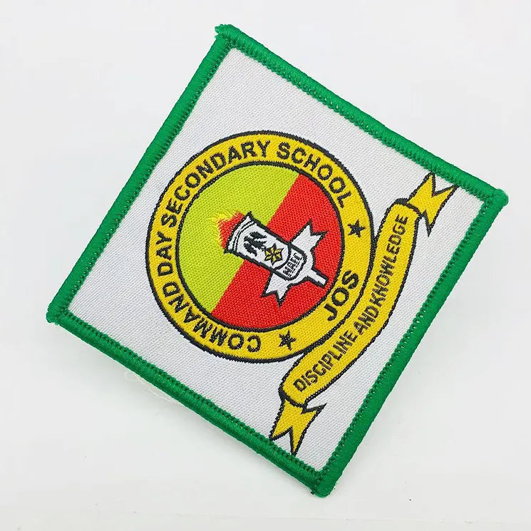 Custom embroidered Community Day Secondary School Jos badge patch with a torch emblem and “Discipline and Knowledge” banner