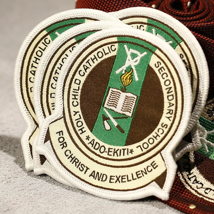 Cream circular badges with green and brown central emblems and surrounding lettering