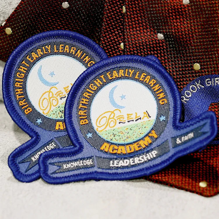 Custom blue embroidered early learning academy patches with crescent moon, stars and leadership banner