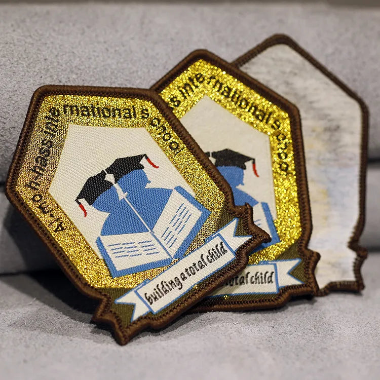 Gold and white shield-shaped school badges with a blue central crest