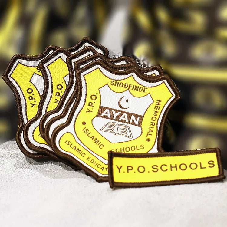 Custom embroidered Islamic school badge patches with yellow shield, book and crescent design