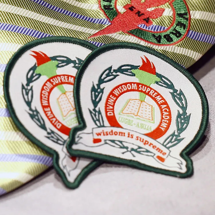 Custom embroidered academic school patches with open book, laurel wreath and red-green torch emblem