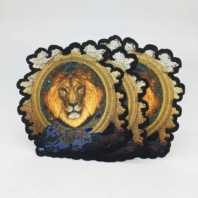 Custom embroidered lion head patches with gold circular border and blue accents