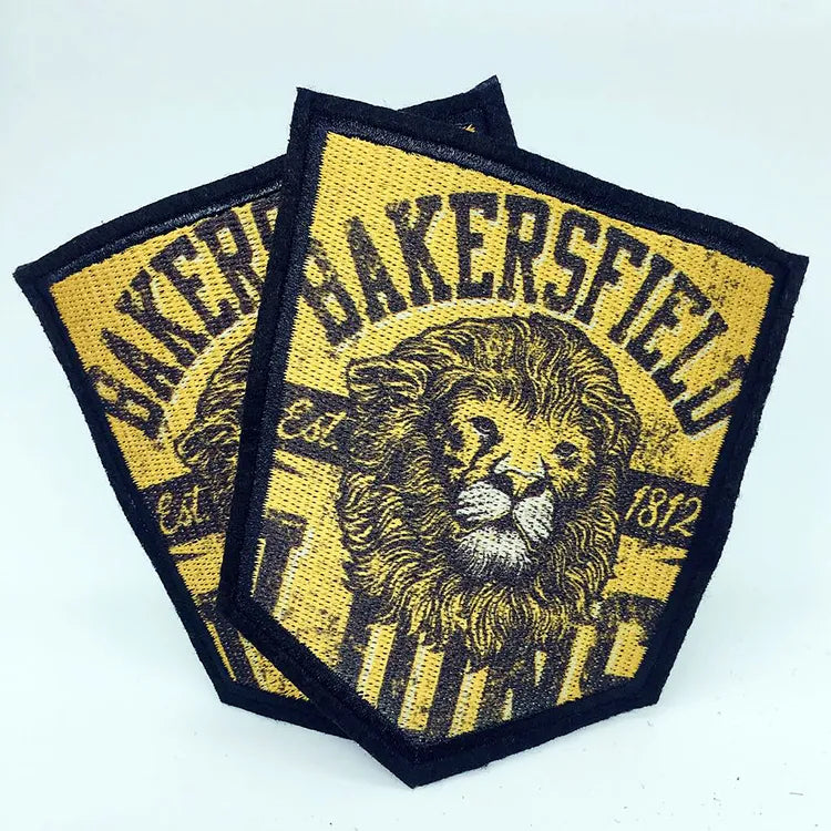Custom yellow and black embroidered lion patches with shield shape and vintage lettering