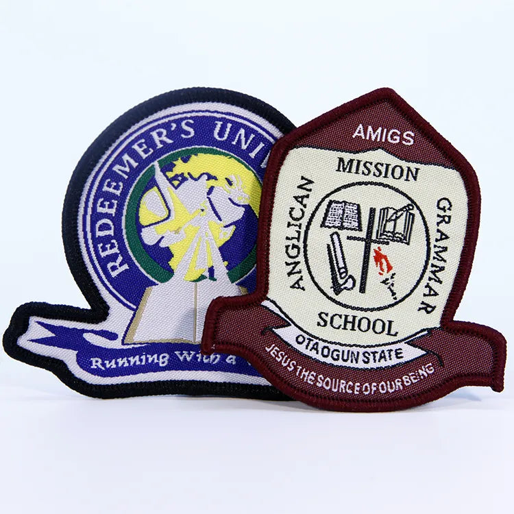 Custom embroidered school emblem patches featuring Redeemer's University and Anglican Mission Grammar School badges