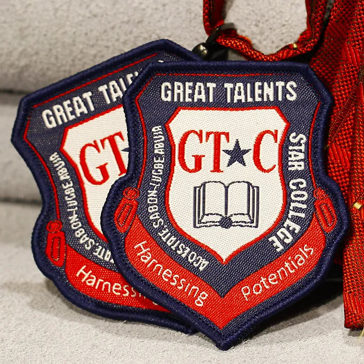 Custom navy, red and white embroidered school crest patches with book emblem and Great Talents lettering