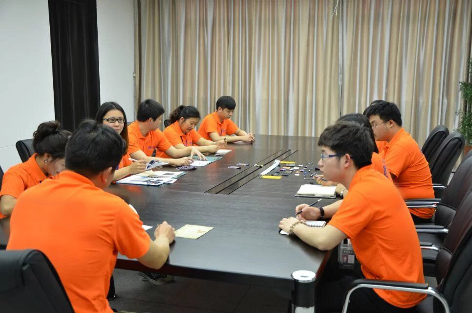 Guystalent staff discussing work around a meeting table