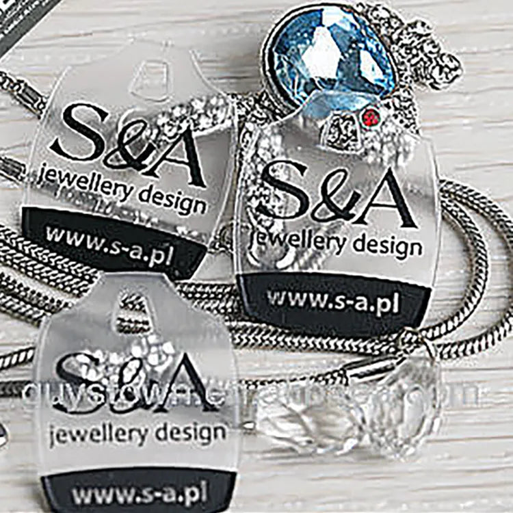 Cluster of clear plastic jewelry tags highlighting clean logo print