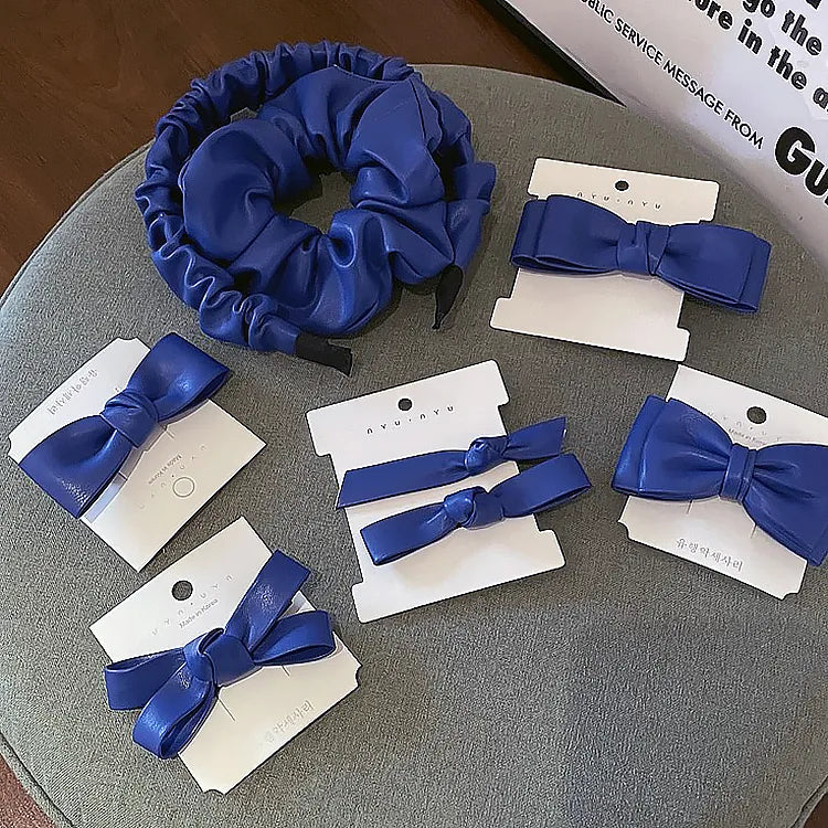 Royal blue leather hair clips mounted onto white custom die-cut accessory cards