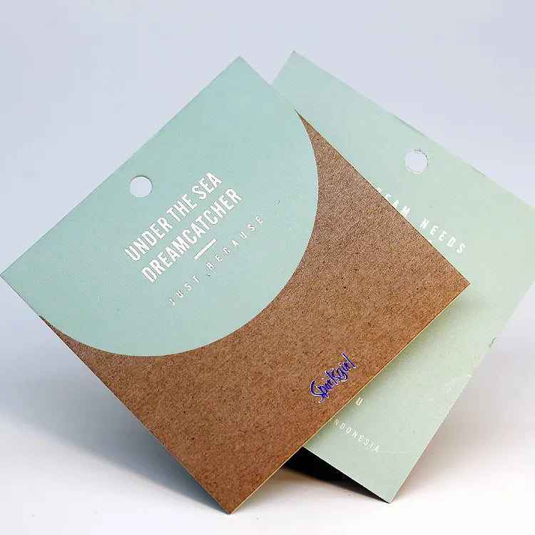 Square pastel mint green and natural kraft cardboard product branding card with silver foil stamped lettering and hanging hole