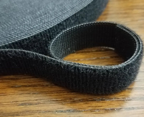 Textured hook and loop fastening surface and woven back on a wooden table